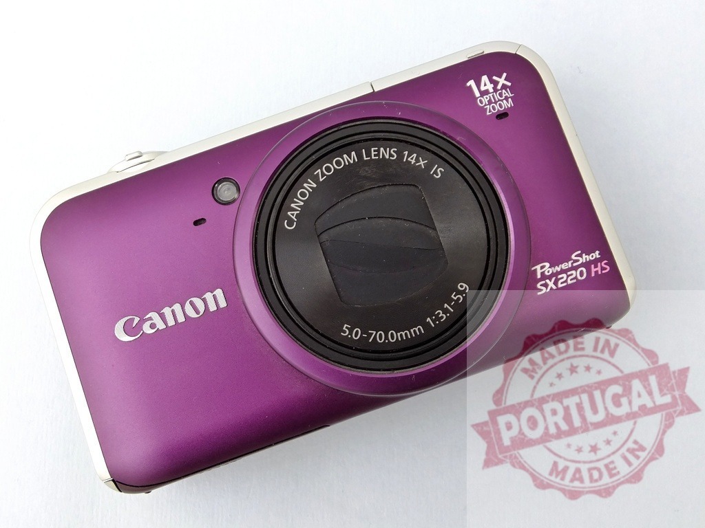 Canon PowerShot SX220 HS digital camera point-and-shoot | Purple Canon PowerShot SX220 HS compact digital camera displaying its lens and zoom capabilities - Realized with Pictrs.com