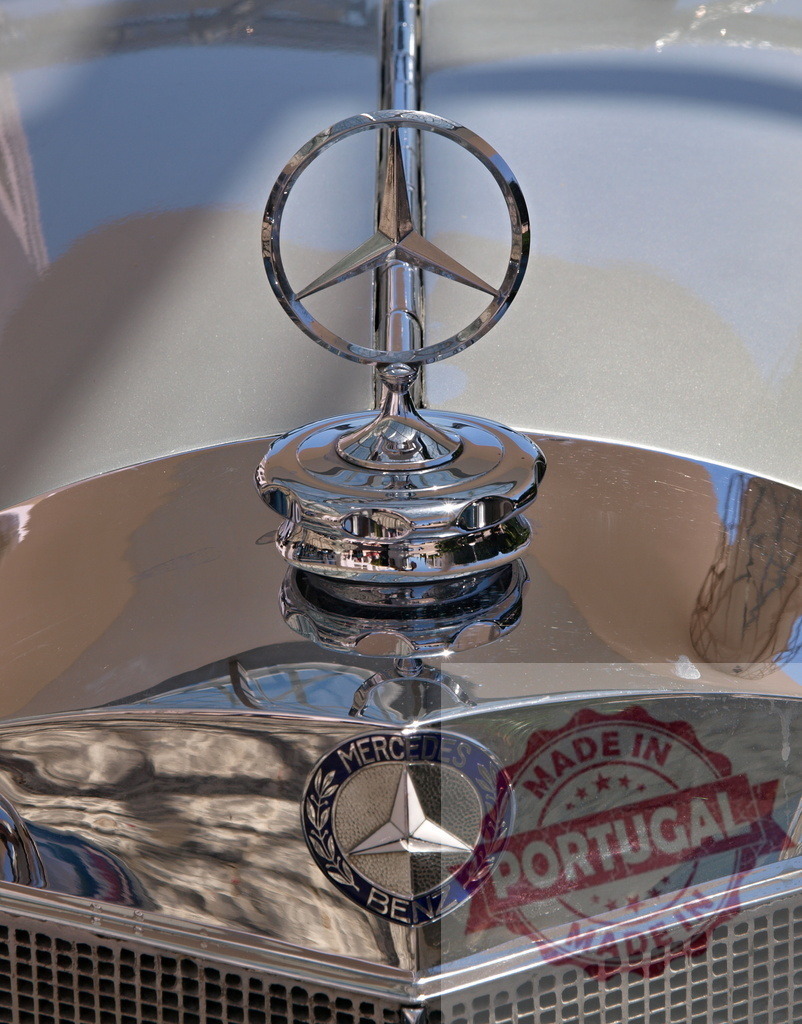 Mercedes-Benz hood ornament shining on vintage car | Polished chrome Mercedes-Benz logo reflecting light on classic car - Realized with Pictrs.com