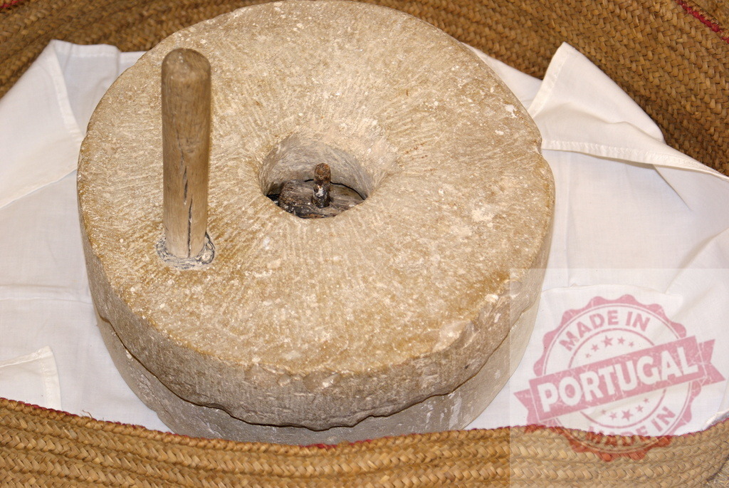 Ancient hand mill quern stone for grinding flour | Hand mill with quern stones representing traditional grain grinding - Realized with Pictrs.com