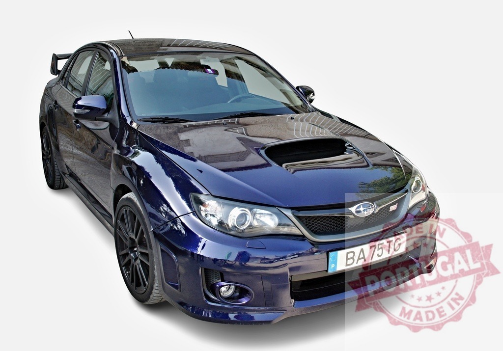 Subaru WRX STI parked and showing its sporty design | Dark blue Subaru WRX STI parked on a white background, highlighting its sporty features and modified hood - Realized with Pictrs.com