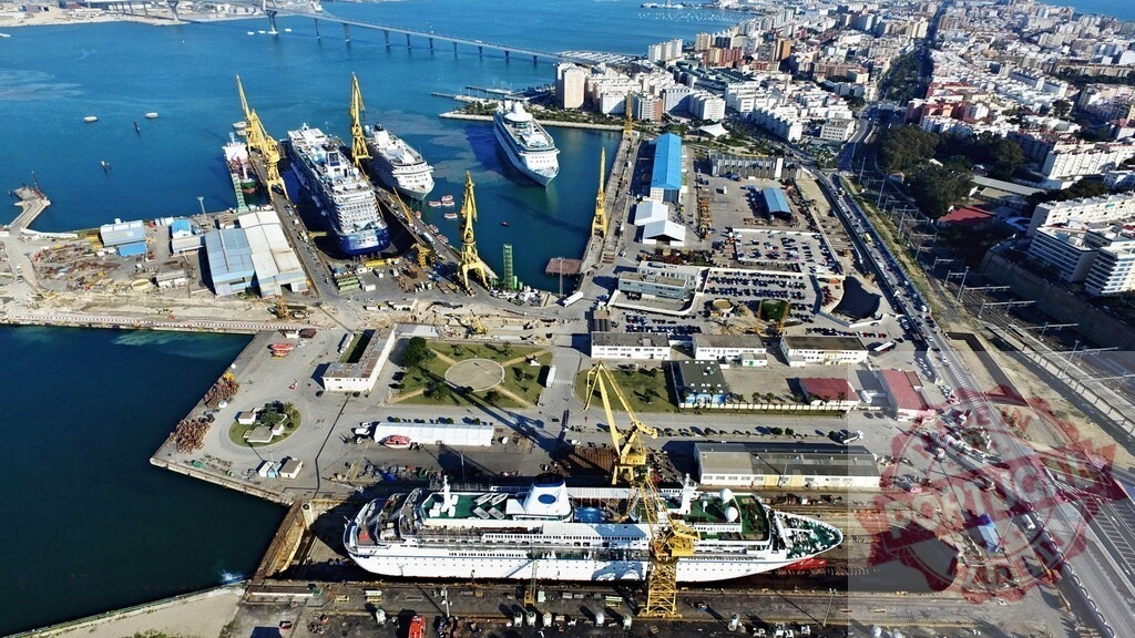 Cádiz port shipyard with cruise ships in dry dock. Espana - Cadiz | Aerial view of Cádiz port showing a shipyard with various cruise ships undergoing maintenance and repairs - Realized with Pictrs.com