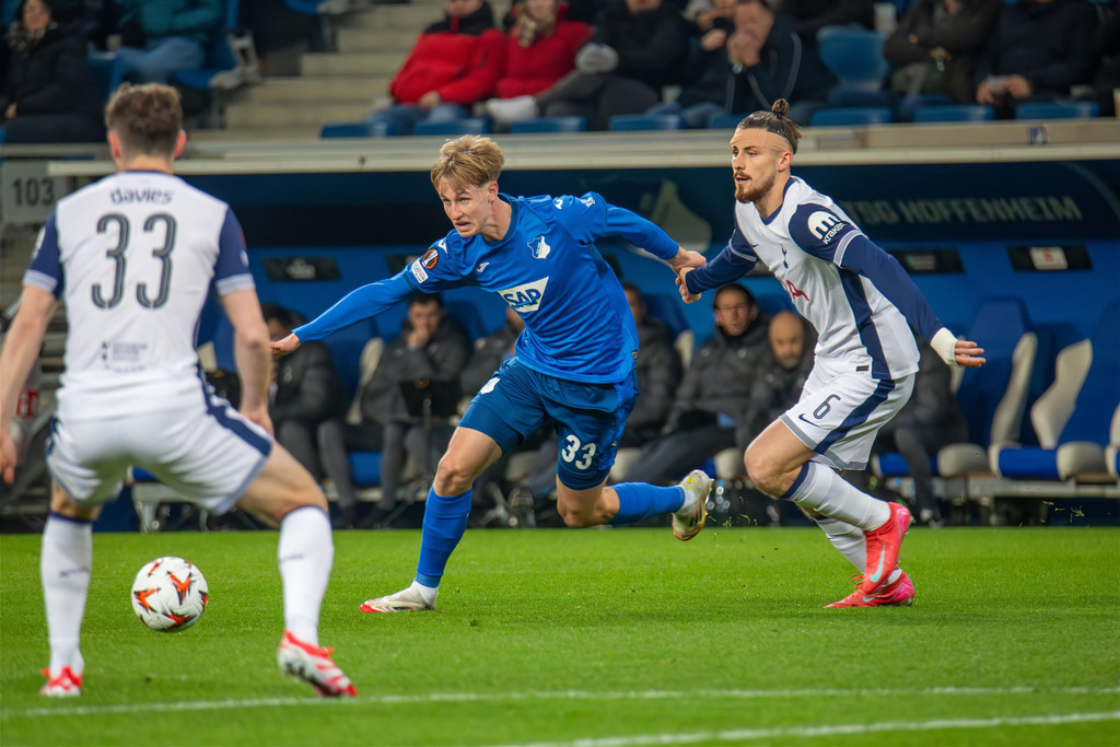 Fußball UEFA Europa League, Saison 2024/25, 7. Spieltag: TSG Hoffenheim gegen Tottenham Hotspur. Bild: Zweikampf zwischen Max Moerstedt (33, Hoffenheim) und Radu Dragusin (6, Tottenham) | Fußball UEFA Europa League, Saison 2024/25, 7. Spieltag: TSG Hoffenheim gegen Tottenham Hotspur. Bild: Zweikampf zwischen Max Moerstedt (33, Hoffenheim) und Radu Dragusin (6, Tottenham) - Realisiert mit Pictrs.com