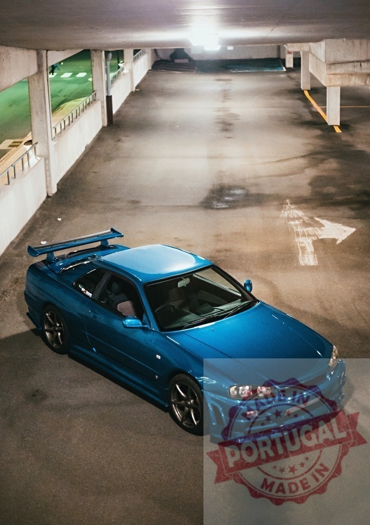 Blue Nissan Skyline GT-R R34 in parking garage | Blue Nissan Skyline GT-R R34 sports car parked inside an urban multi-story garage at night - Realisiert mit Pictrs.com