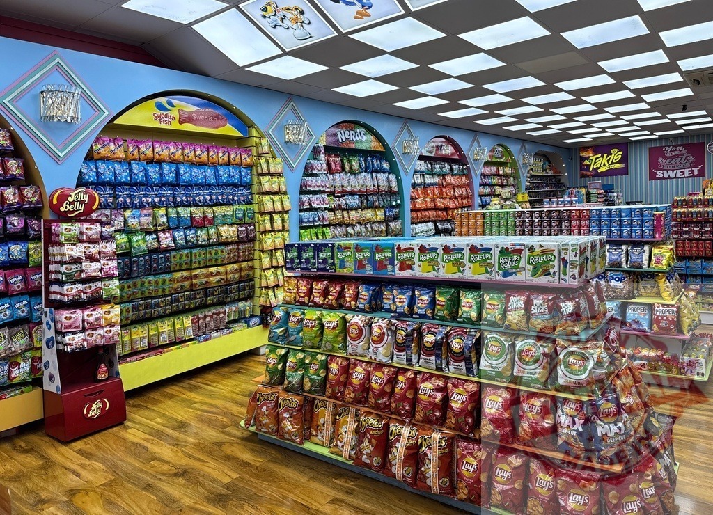 Colorful candy and snack store interior displaying products | Retail store interior with shelves packed full of colorful candy and snack products - Realized with Pictrs.com