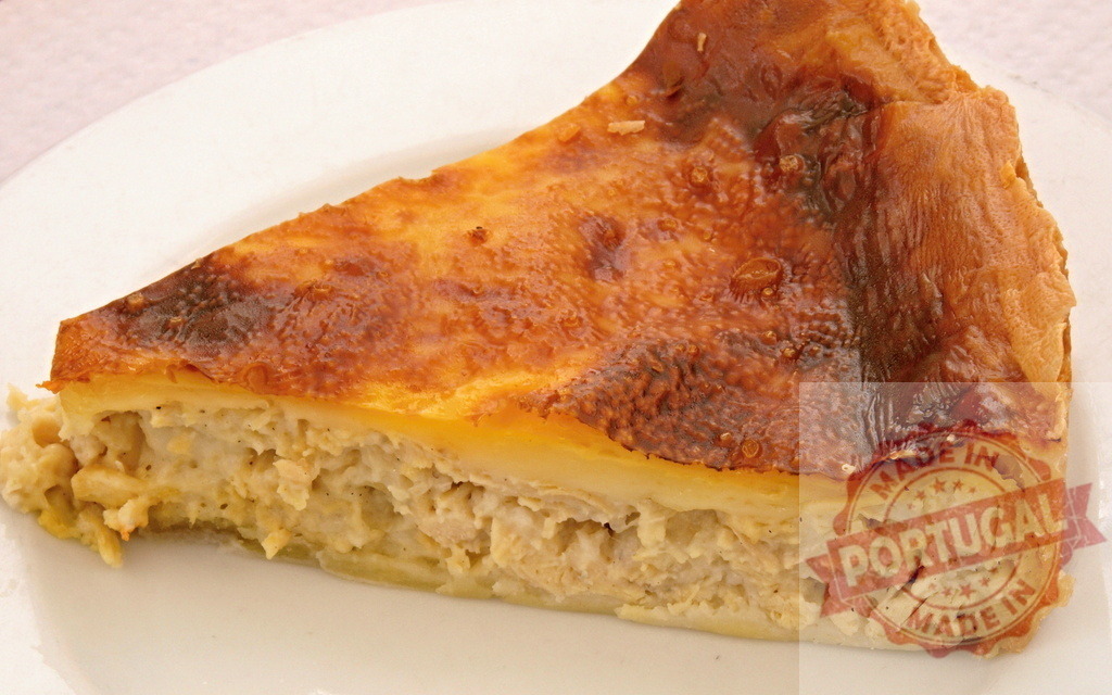 Golden savory chicken quiche slice on white plate | Delicious chicken quiche slice as a baked savory pie for breakfast, brunch, or lunch - Realized with Pictrs.com