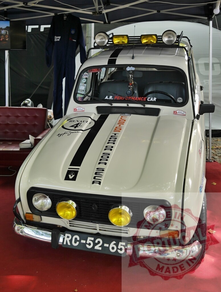Renault 4L classic rally car at event show | Vintage Renault 4L rally car featuring auxiliary lights and black racing stripes - Realized with Pictrs.com