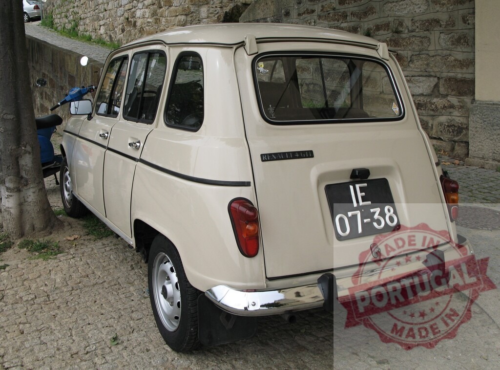 Renault 4L parked near a stone wall | Back view of a beige vintage Renault 4L parked on a cobblestone street next to a stone wall - Realized with Pictrs.com