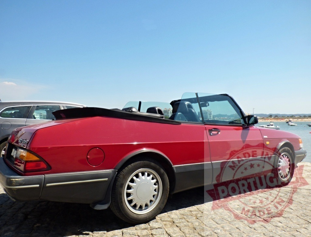 Classic red Saab 900 convertible parked near the sea enjoying summer holidays | Shiny red Saab 900 convertible parked on a cobblestone street near the sea, enjoying summer holidays - Realized with Pictrs.com