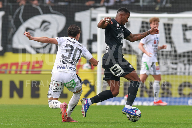 SK Puntigamer Sturm Graz vs TSV Egger Glas Hartberg – Championship Group    | Graz, Austria, 12.Apr.26 - SOCCER - ADMIRAL Bundesliga, SK Puntigamer Sturm Graz vs TSV Egger Glas Hartberg. The image shows Lukas Fridrikas (Hartberg) and Jeyland Mitchell (STU).    