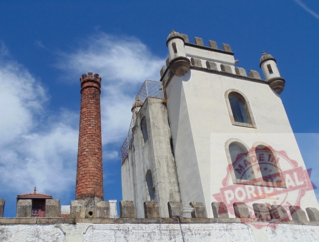 Museu de Ovar historic building with brick chimney. Aveiro - Portugal | Museu de Ovar showing its white tower and tall brick chimney under a blue sky - Realized with Pictrs.com