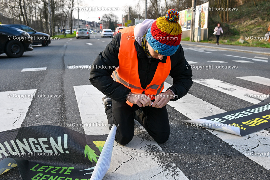  Klimagegner Linz Waldeggstrasse_ Klimakleber_ 20.03.2023-23 | 20.03.2023, Linz, AUT, Klimagegner Linz Klimakleber, im Bild Klimagegner kleben auf der Strasse, Linz Waldeggstrasse, Polizei, Verkehr, Zebrastreifen, Fussgaengeruebergang, Transparent, Demo, Klimawandel