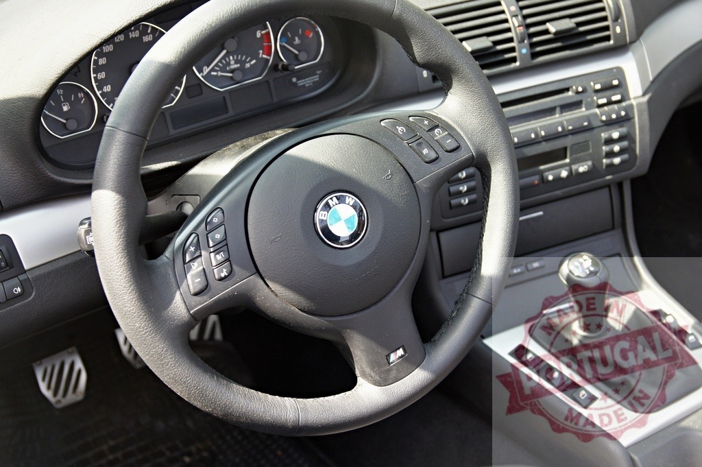 BMW car interior with steering wheel and dashboard | BMW car interior showing the steering wheel, dashboard, and gear shift - Realized with Pictrs.com