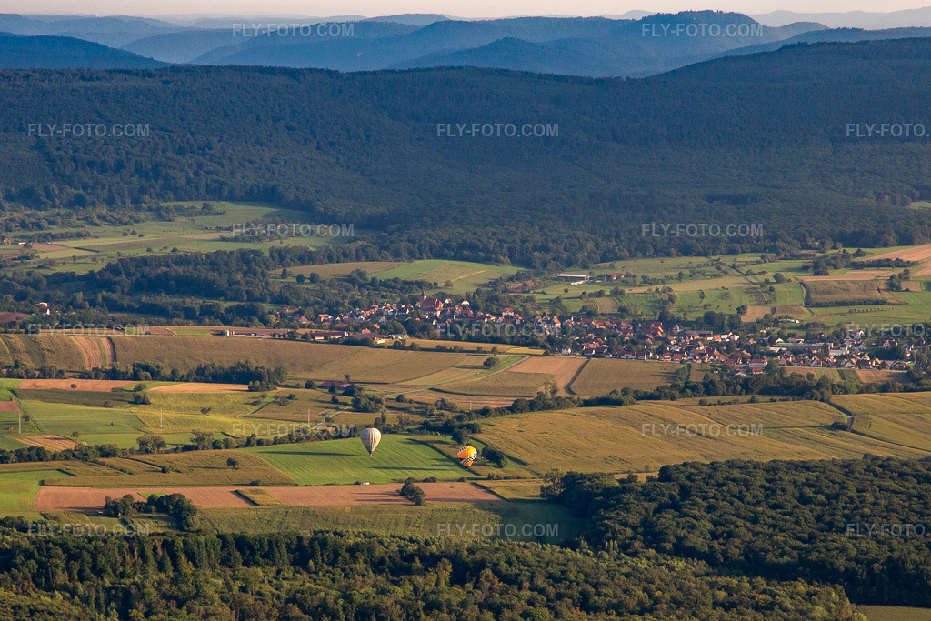 Aerial view: Landing of two hot air balloons in Morsbronn-les-Bains in the state Bas-Rhin, France.Photo: IMG_138088.jpg taken on 08/19/2023 by Werner Riehm/FLY-FOTO.comResolution of the original: 3869 x 2579 px