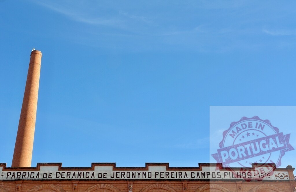 Jeronymo Pereira Campos ceramic factory chimney against blue sky | Industrial brick chimney rising above the old ceramic factory building under a clear blue sky - Realized with Pictrs.com