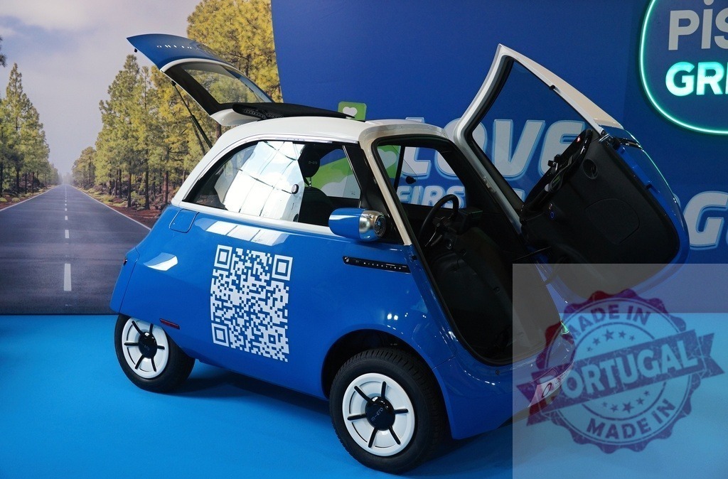 Blue Microlino electric city car opening doors for micro-mobility | Blue Microlino electric vehicle displaying a QR code for urban transportation and sustainable living - Realized with Pictrs.com