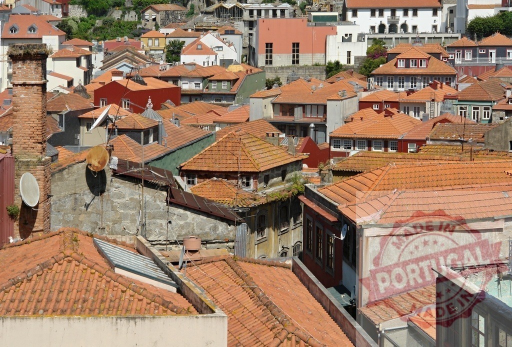 Porto cityscape with traditional red tiled rooftops | Porto Ribeira district from above showing multiple buildings and historic architecture - Realized with Pictrs.com