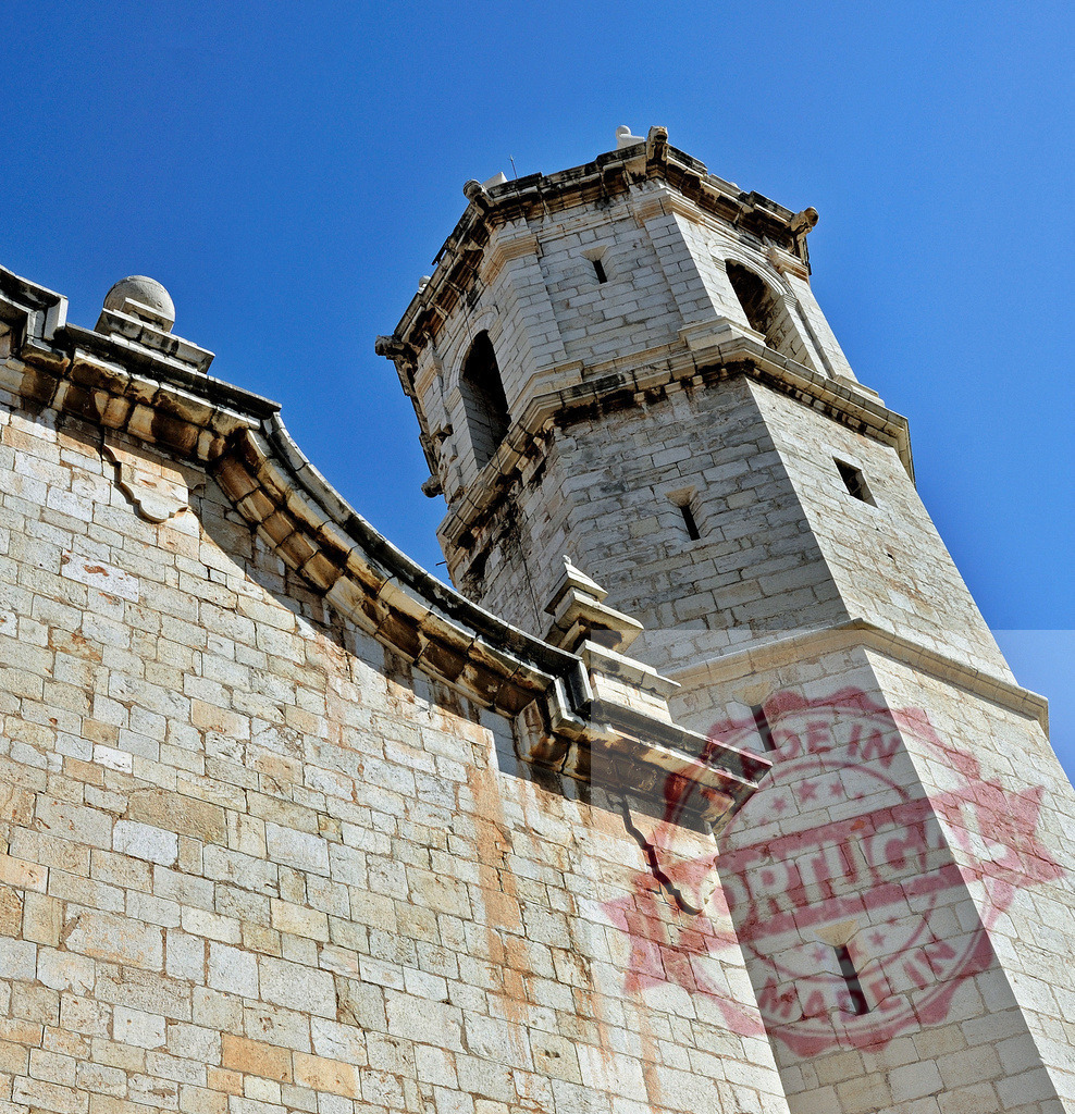Church of Santa Maria de Peñíscola stone bell tower | Stone bell tower and church facade rising against a clear blue sky - Realized with Pictrs.com