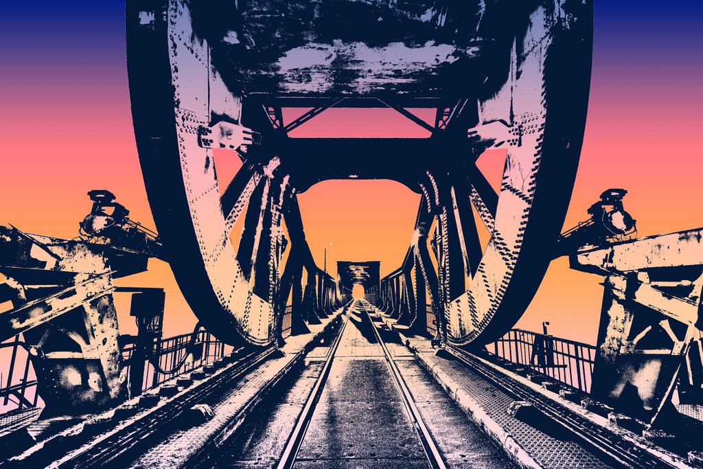 Photoart: Abendrot an der Lindaunisbrücke | Dieses Wandbild im Querformat zeigt die künstlerische Interpretation der Schleibrücke in einem Farbverlauf aus warmen Farbtönen. Das Bild bietet einen schönen Fluchtpunkt über die gesamte Brücke. Die Eisenbahnschienen auf der Brücke verstärken noch diesen Effekt. - Realized with Pictrs.com