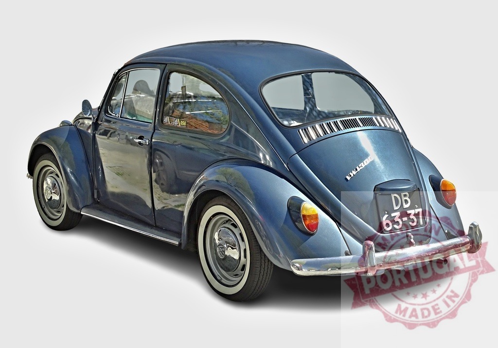 Classic Volkswagen Beetle shining in metallic blue paint parked on a plain background | Vintage Volkswagen Beetle car in metallic blue paint with whitewall tires parked on a plain background, showcasing its timeless design - Realisiert mit Pictrs.com