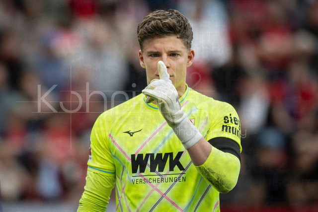 German Bundesliga, Bayer 04 Leverkusen vs. FC Augsburg, 18.04.2026 | LEVERKUSEN, GERMANY - APRIL 18, 2026 :  Keeper Finn Dahmen (FC Augsburg, 1) tries to flukes after an injury during the German Bundesliga match on gameday 30 between Bayer 04 Leverkusen vs. FC Augsburg at BayArena on April 18, 2026 in Leverkusen, Germany. DFL REGULATIONS PROHIBIT ANY USE OF PHOTOGRAPHS AS IMAGE SEQUENCES AND/OR QUASI-VIDEO.