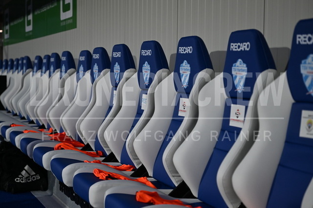 TSV Egger Glas Hartberg vs SV Oberbank Ried – Austrian Bundesliga Match | TSV Egger Glas Hartberg and SV Oberbank Ried. High-intensity match action, tackles, shots on goal, celebrations, fan atmosphere and stadium scenes captured in professional quality. The image shows the new chairs from Hartberg.