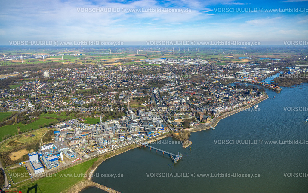 Emmerich240313242 | Luftbild, KLK Emmerich Chemiewerk, Stadtansicht und Rheinpromenade Fluss Rhein, Rathaus Stadtverwaltung am Geistmarkt, kath. Kirche St. Aldegundis und evang. Christuskirche und kath. Kirche St. Martini, Fernsicht mit Windräder im Hintergrund, Containerhafen, Emmerich, Emmerich am Rhein, Nordrhein-Westfalen, Deutschland
