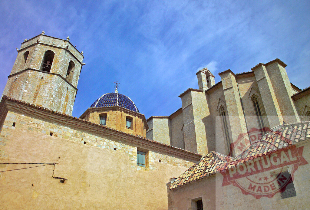 Traditional Spanish church architecture with bell tower and blue dome | Historic church showcasing traditional architecture, a bell tower, and a vibrant blue tiled dome - Realized with Pictrs.com