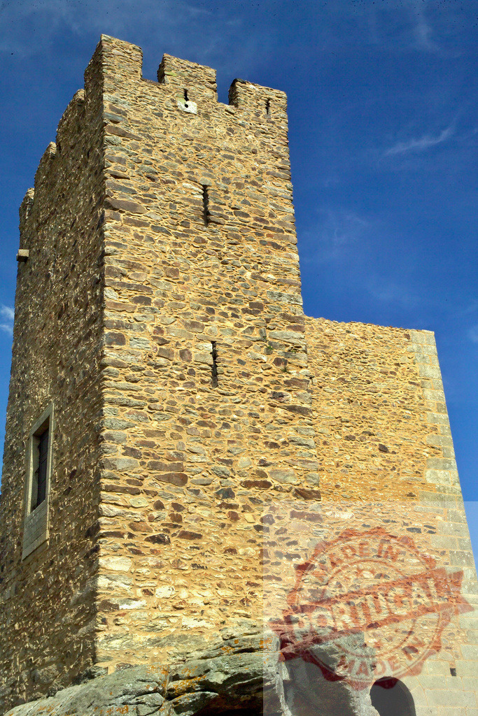 Medieval stone castle tower under blue sky | Old fortress architecture standing tall against a clear sunny day - Realized with Pictrs.com