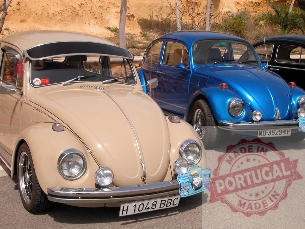 Two classic Volkswagen Beetles parked side by side | Two customized classic Volkswagen Beetles are parked in a parking lot, showcasing their unique colors and modifications - Realisiert mit Pictrs.com