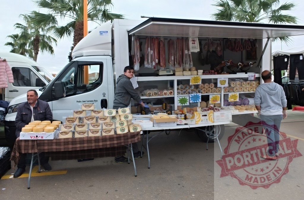 Food truck selling cheese and cured meat at an outdoor market | Vendors proudly display cheese wheels, deli meats, and sausages from a truck store at a street market - Realized with Pictrs.com