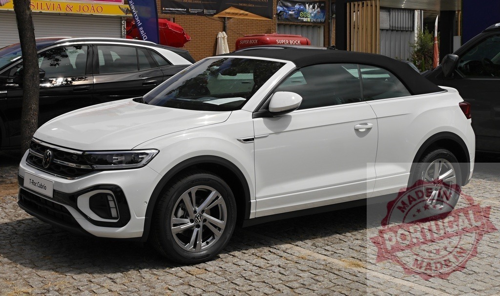 Volkswagen T-Roc Cabriolet modern white convertible SUV | Volkswagen T-Roc Cabriolet parked on cobblestone street - Realized with Pictrs.com