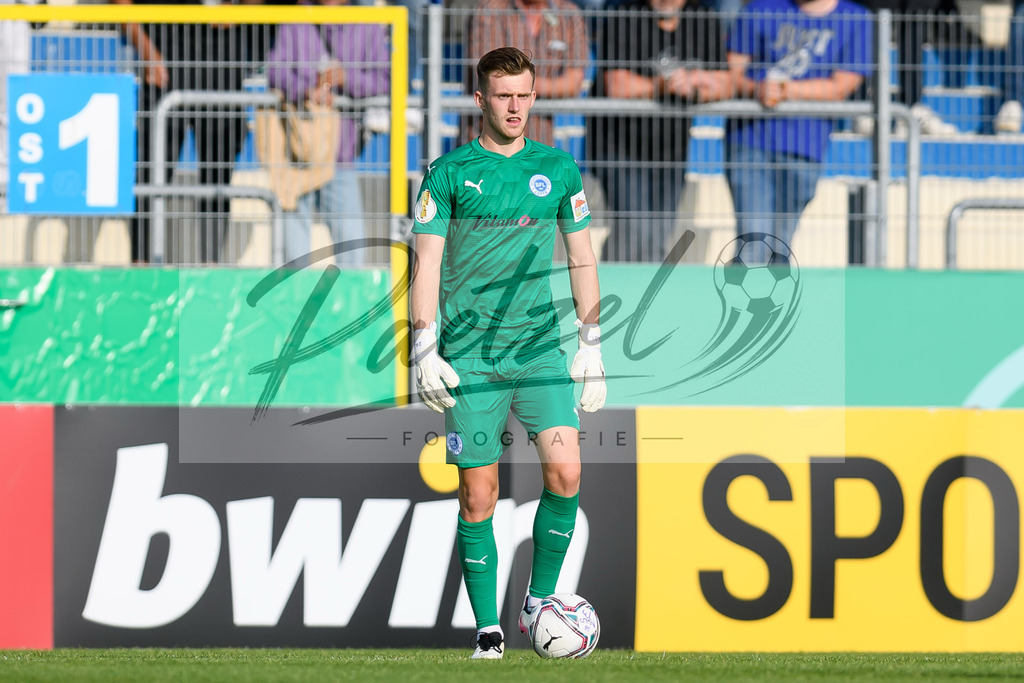 LOTKSC20210809_099 | Fussball, Herren: Torwart Jhonny Peitzmeier (Sportfreunde Lotte) in Aktion, am Ball, Einzelaktion beim Spiel der 1. Runde im DFB-Pokal zwischen SF Lotte und Karlsruher SC im Stadion am Lotter Kreuz am 09.08.2021 in Lotte, Deutschland.DFB / DFL REGULATIONS PROHIBIT ANY USE OF PHOTOGRAPHS AS IMAGE SEQUENCES AND/OR QUASI-VIDEO. - Realisiert mit Pictrs.com