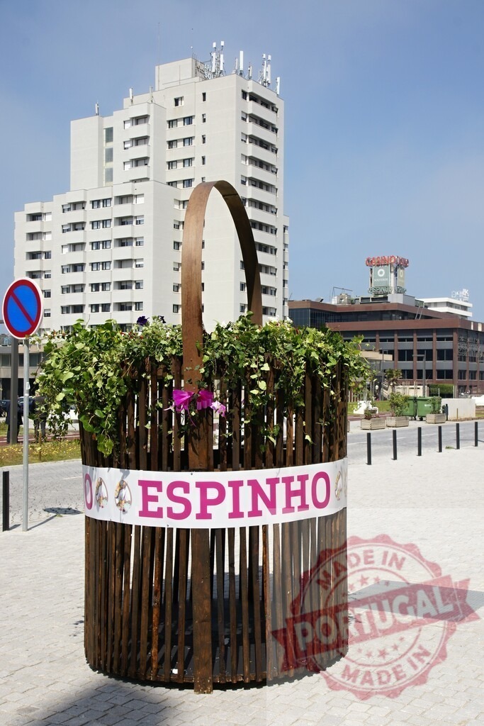 Espinho city street featuring large flower basket public art | Espinho flower basket urban sculpture with buildings and blue sky - Realized with Pictrs.com