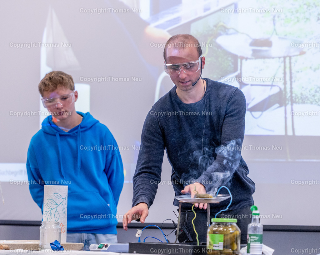 DSC_9929 | Karl-Kübel_Schule, Experimente-Show im Küchenlabor, Ganz ohne komplizierte Laboraufbauten und fremde Chemikalien zeigt Elias Chalwatzis gemeinsam mit Schülerinnen und Schülern in einem eigenen Küchenlabor verschiedene Effekte und bietet einiges zum Probieren an. Bild: Die beiden Enden einer Gewürzgurke werden an Netzspannung U = 230 V angeschlossen. Wird der Stromkreis geschlossen, beginnt die Gurke an einem Ende zu leuchten, gleichzeitig entsteht dort Dampf. Nach längerer Versuchsdauer zeigen sich an dem Ende, das geleuchtet hat, auch Schmorspuren. Bild:  Bild: Thomas Neu
