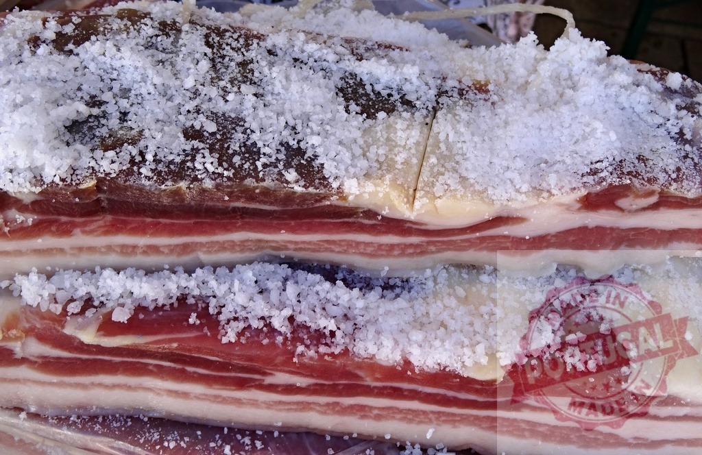 Curing pork belly with coarse salt for pancetta | Pork belly heavily covered with coarse salt, preparing for traditional curing - Realisiert mit Pictrs.com
