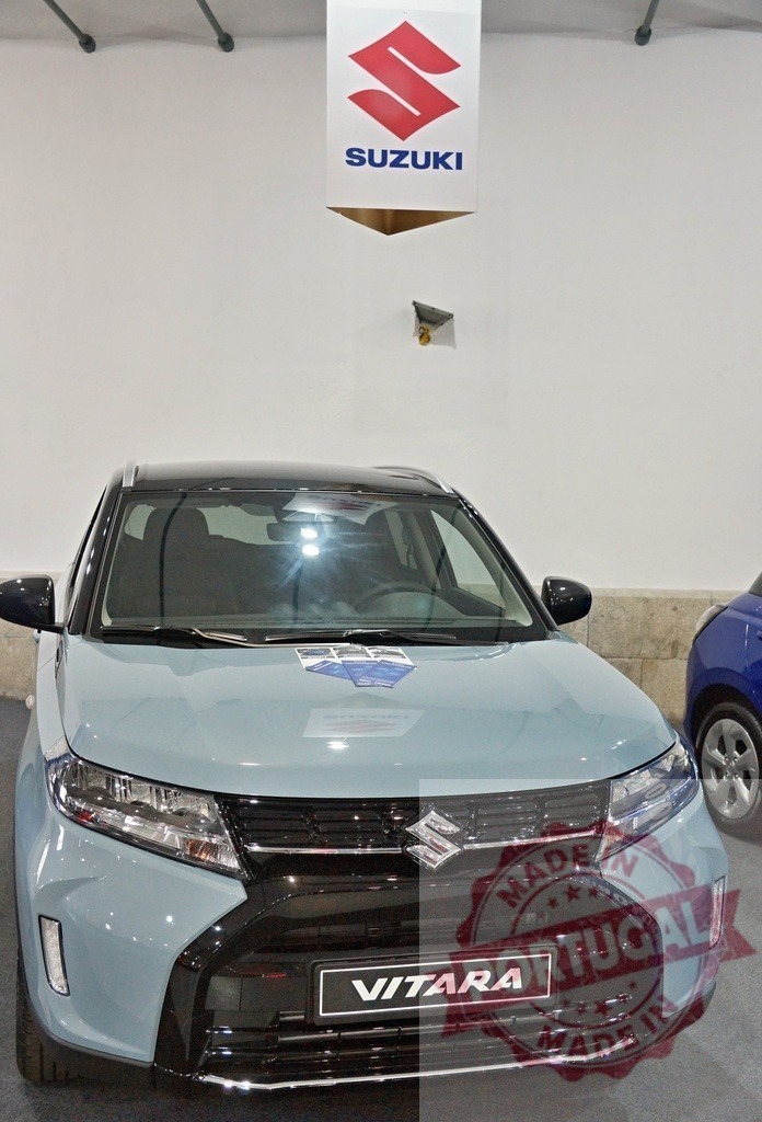 Suzuki Vitara SUV showcasing modern automobile design | Suzuki Vitara SUV on display in a showroom, representing the automotive industry - Realized with Pictrs.com