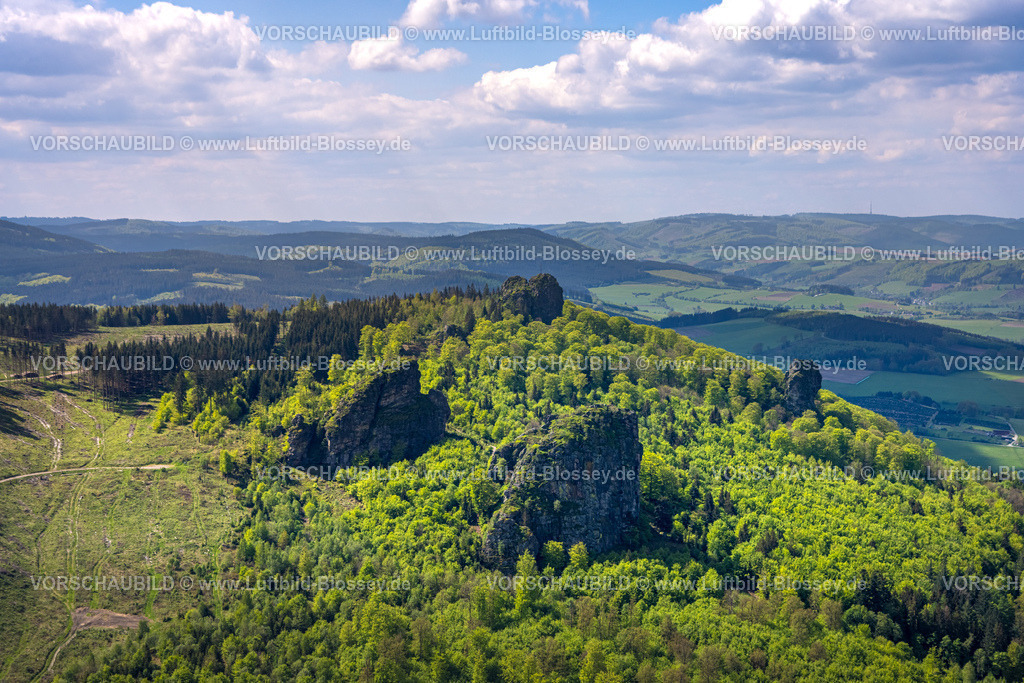 Olsberg240503766 | Luftbild, Bruchhauser Steine, Sehenswürdigkeit in waldiger Hügellandschaft, vier Felsen mit Namen Ravenstein, Goldstein, Bornstein und Feldstein mit Gipfelkreuz, Fernsicht mit blauem Himmel und Wolken, Bruchhausen, Olsberg, Sauerland, Nordrhein-Westfalen, Deutschland