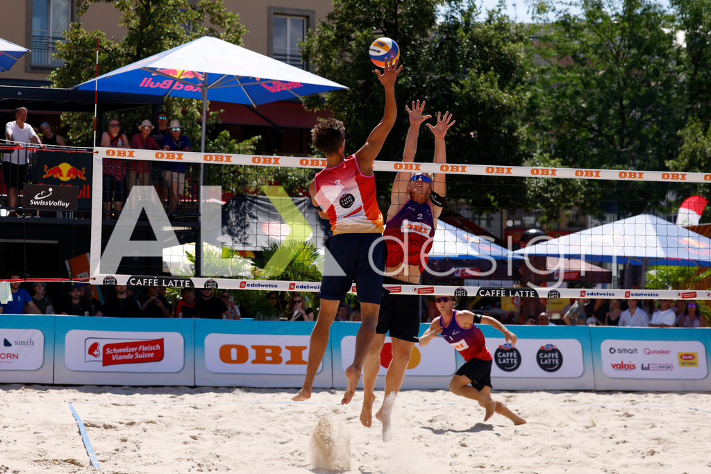 Obi BeachTour 2026 - Basel | BASEL, SWITZERLAND - JULY 18: LUC EMANUEL FLÜCKIGER (SUI) attack / spike against MATHIS KÄLIN (SUI) block during the Obi BeachTour 2026 match between DILLIER / FLÜCKIGER (SUI) and BREER / KÄLIN (SUI) at Barfüsserplatz on July 18, 2026 in Basel, Switzerland. - Realisiert mit Pictrs.com