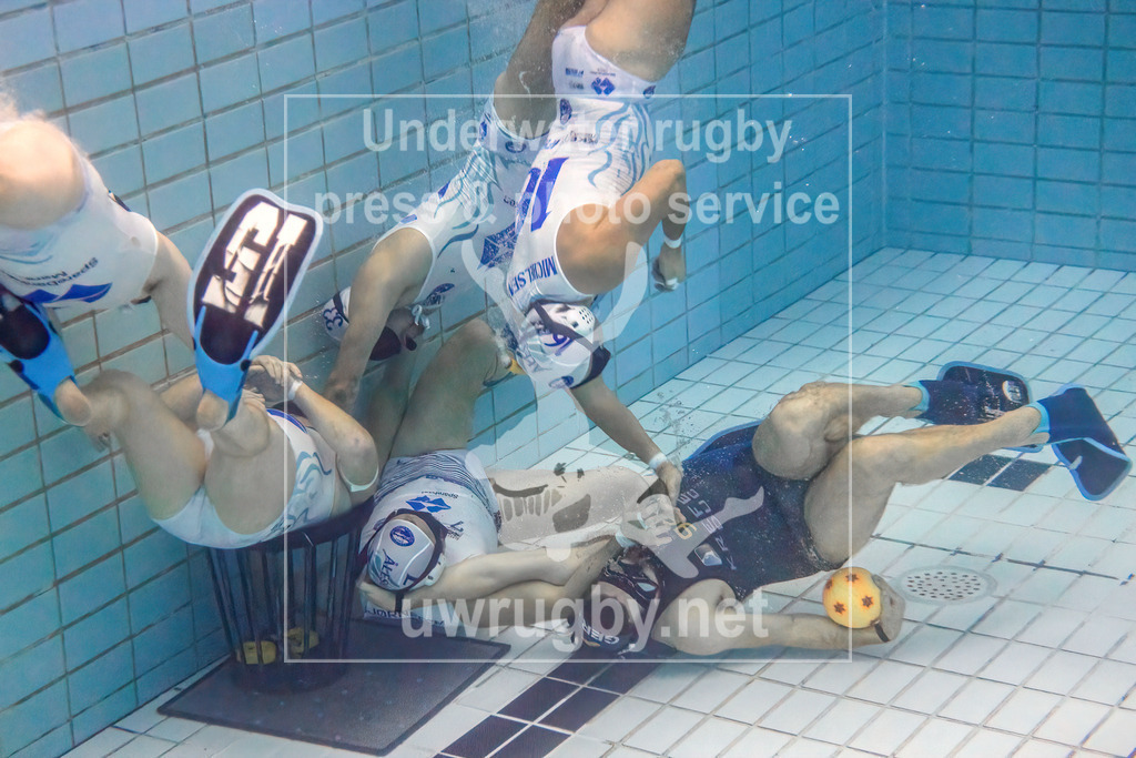 24. - 26.11.2023: Unterwasser-Rugby Champions Cup 2023  | Herren-Halbfinale: DUC Krefeld (Deutschland) in blau gegen Ålesund (Norwegen) in weiß. Der deutsche Meister Max Keiten (blau #98) verteidigt den Ball gegen 5 norwegische Spieler an deren Tor. - Realisiert mit Pictrs.com