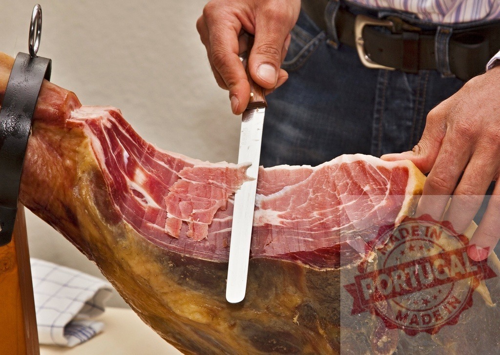 Hand carving traditional Jamón Ibérico with a sharp knife | Hand slicing cured Spanish Ibérico ham for a delicious gourmet meal - Realized with Pictrs.com