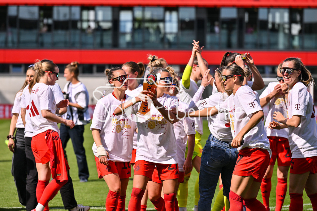 FC Bayern München - SC Freiburg | Die Spielerinnen des FC Bayern feiern die Meisterschaft nach dem Heimsieg gegen den SC Freiburg / Frauen Bundesliga: FC Bayern Muenchen - SC Freiburg, FC Bayern Campus am 27.04.2025 / Arianna CARUSO (FC Bayern Muenchen Frauen 27) gibt Klara BUEHL (FCB #17) einen Schluck auf dem Paulaner Bierkrug / Bierglas