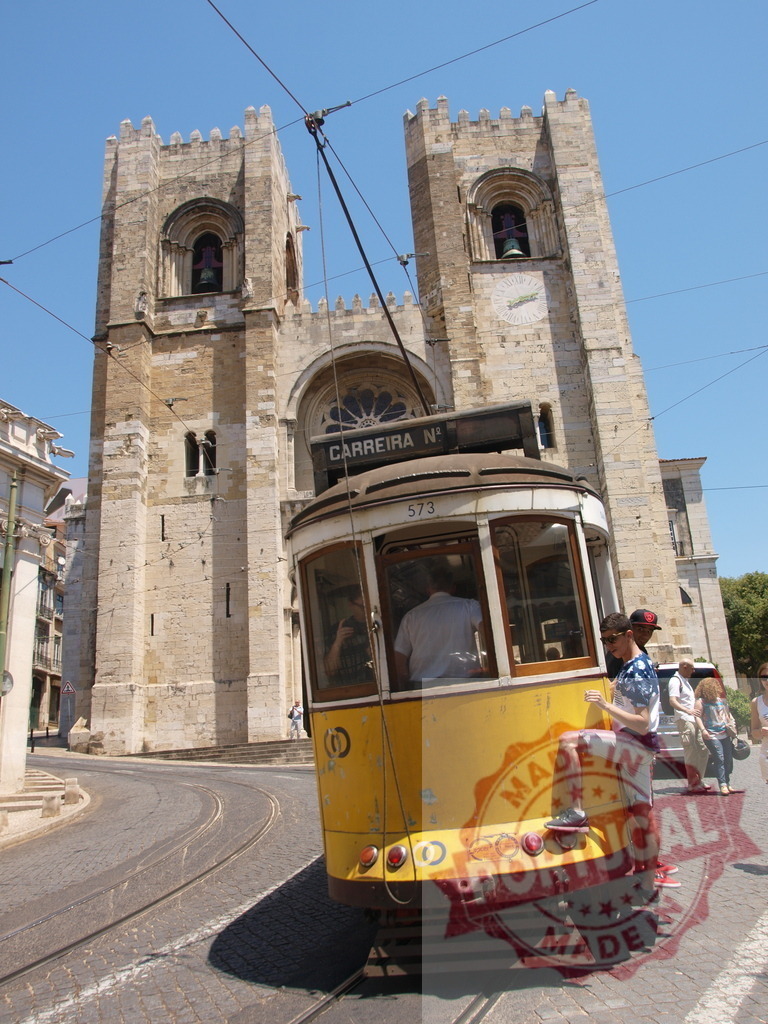 Yellow tram passing in front of Lisbon Cathedral in Portugal | Yellow tram passing in front of the Lisbon Cathedral, in Alfama district, Lisbon, Portugal - Realized with Pictrs.com