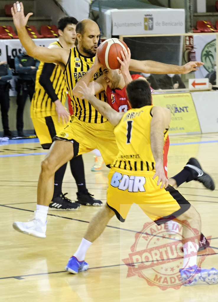 Basketball players competing for ball during a game | Basketball players struggling for possession of the ball on court during a competitive match - Realized with Pictrs.com