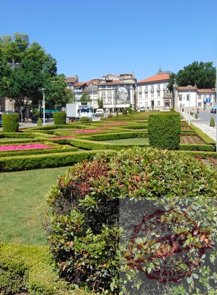 Guimarães, Portugal, Republic Square formal garden with topiary shrubs. Region Norte - Portugal | Republic Square formal garden in Guimarães, Portugal featuring neatly manicured hedges and vibrant flowers - Realized with Pictrs.com