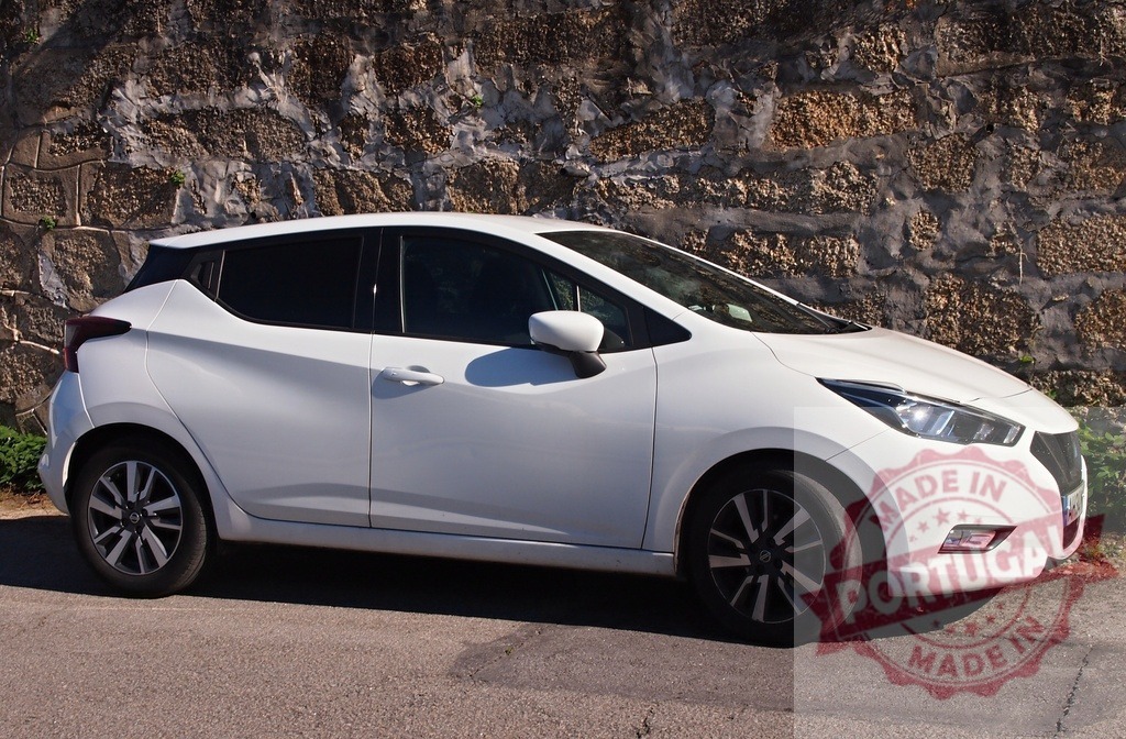 White Nissan Micra subcompact car parking by stone wall | White Nissan Micra hatchback parking on a street next to an old stone wall - Realisiert mit Pictrs.com