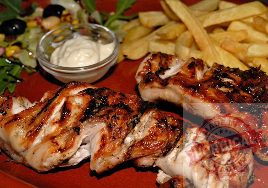 Grilled chicken meal with french fries and fresh salad | Grilled chicken pieces serving as a complete dinner with french fries and a small side salad - Realized with Pictrs.com