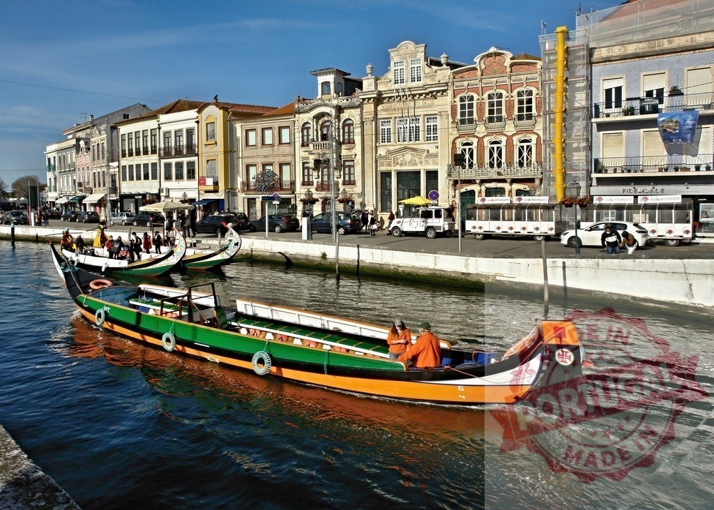 Moliceiro boat cruising Aveiro canal with tourists | Traditional moliceiro boat navigating the canal in Aveiro, Portugal, past historic city buildings - Realized with Pictrs.com