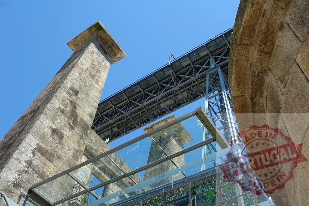 Ponte Luís I bridge architecture in Porto, Portugal | Ponte Luís I bridge structure from a low angle, reflecting in modern glass panels - Realized with Pictrs.com