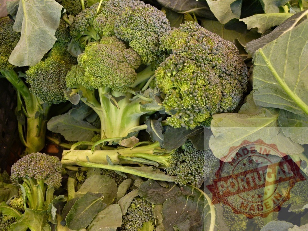 Fresh green broccoli florets ready for healthy cooking | Broccoli florets and leaves in a pile, offering fresh organic healthy food - Realized with Pictrs.com