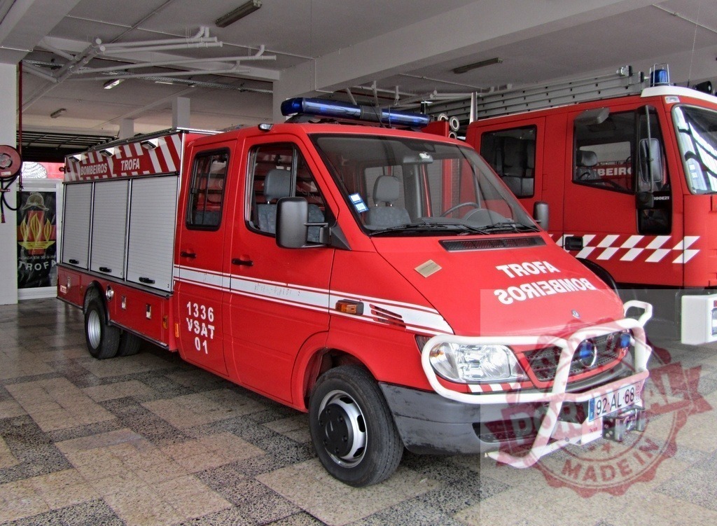Red Bombeiros fire truck inside station in Trofa, Portugal | Red fire truck from Bombeiros Voluntários da Trofa parked inside a fire station - Realized with Pictrs.com